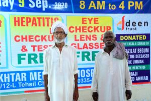 Picture of two senior citizens receiving Hepatitis Vaccination at Deen Trust camp.