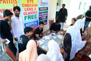 Picture of Deen Trust volunteers administering eye drops to patients in interior Sindh, Pakistan